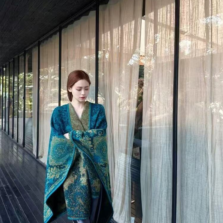 ピーコックの青いストールの外で女性の雲南新疆のチベットの大西北の旅行は写真を撮る民族風のマントを着ます。|undefined