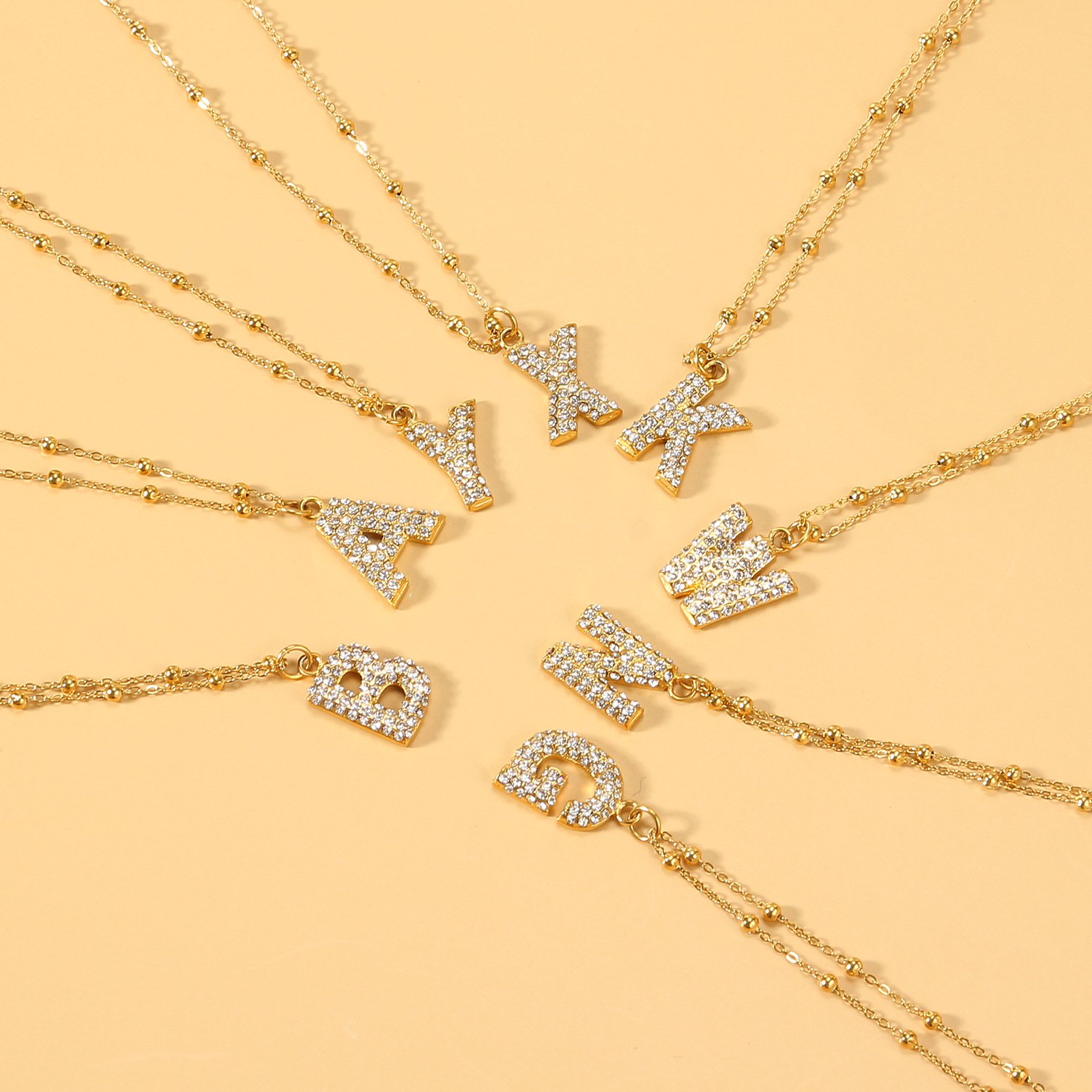 欧美跨境26个英文字母钛钢项链金色微镶锆石个性吊坠锁骨链夹珠链