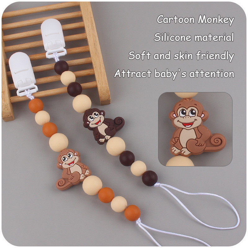 Nuevos suministros para bebés mono de dibujos animados mordedura de chupete de silicona lindo bebé creativo cadena anti-gota cadena