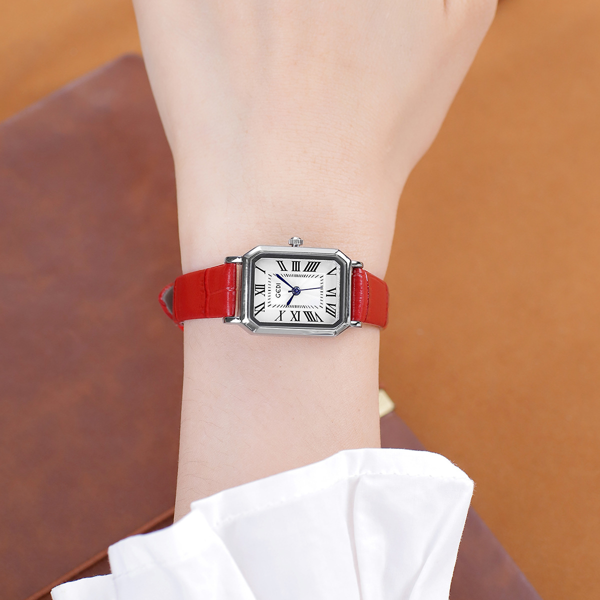 Silver shell white face red belt