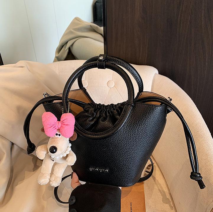 Bolsos de mano de nicho de tendencia transfronteriza para damas 2025 nuevo bolso de hombro simple de moda con textura bolso de cubo de todo fósforo