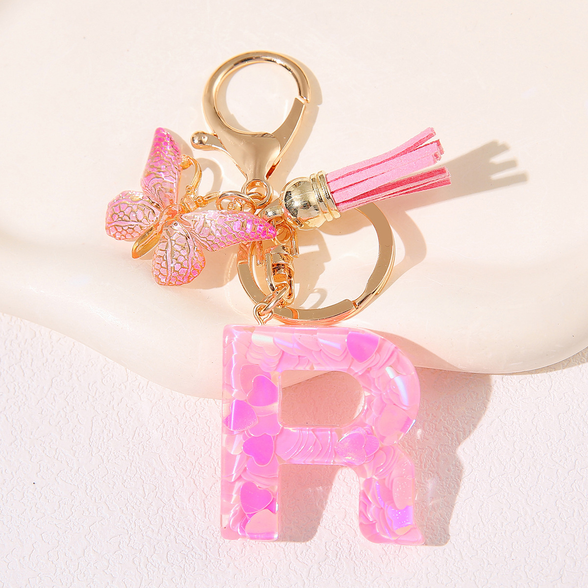 Nuevo rosa damas letras A-Z llavero de goteo de goma sequilla amor letras bordas mariposa llavero transfronterizo