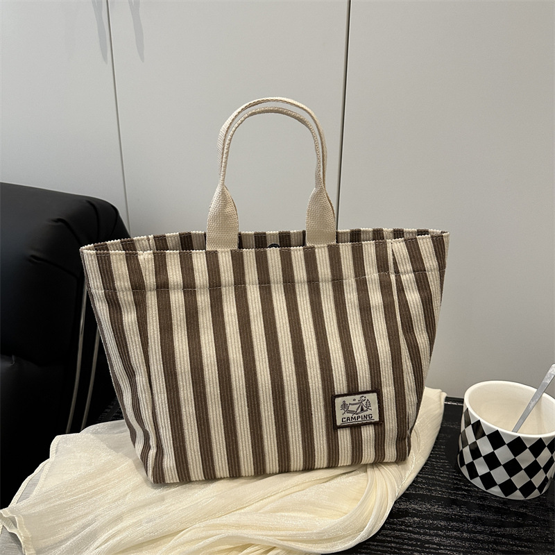 Bolso tote de tela a rayas de estilo europeo y americano, nuevo bolso pequeño de moda, bolso femenino portátil, bolso de almuerzo de mano, bolso de bocadillos