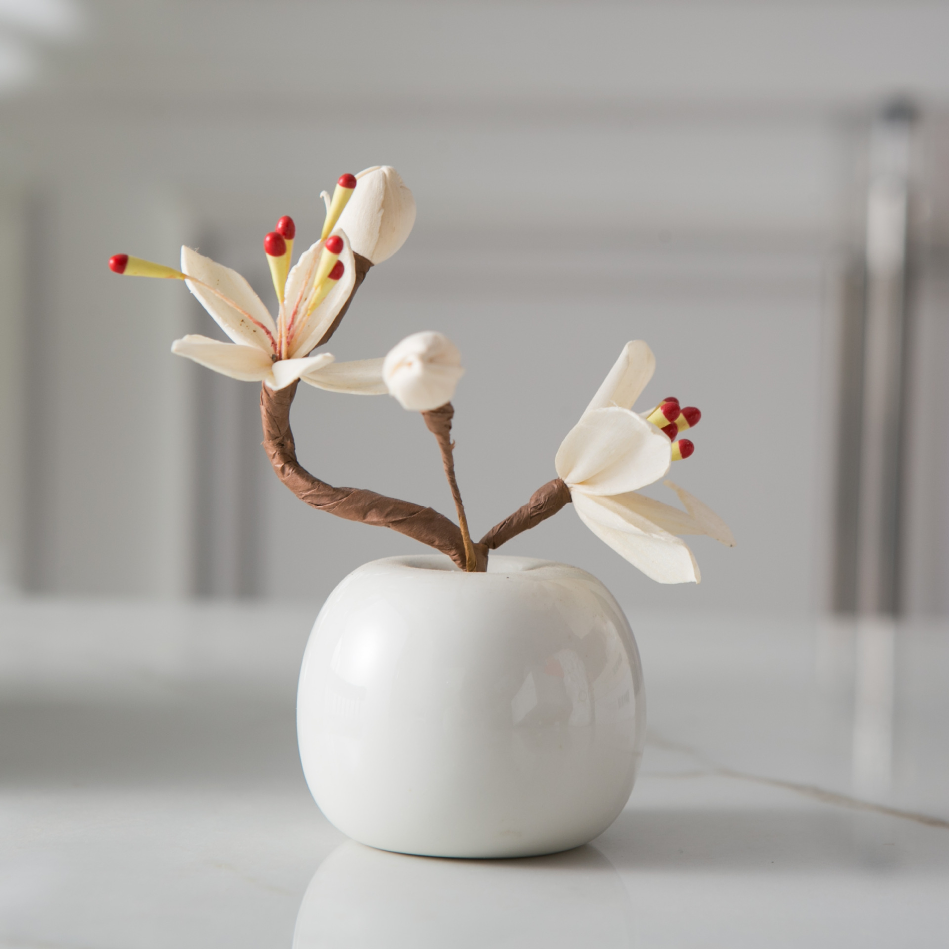 Small white bottle + magnolia flower