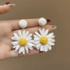 White ear clips, flowered