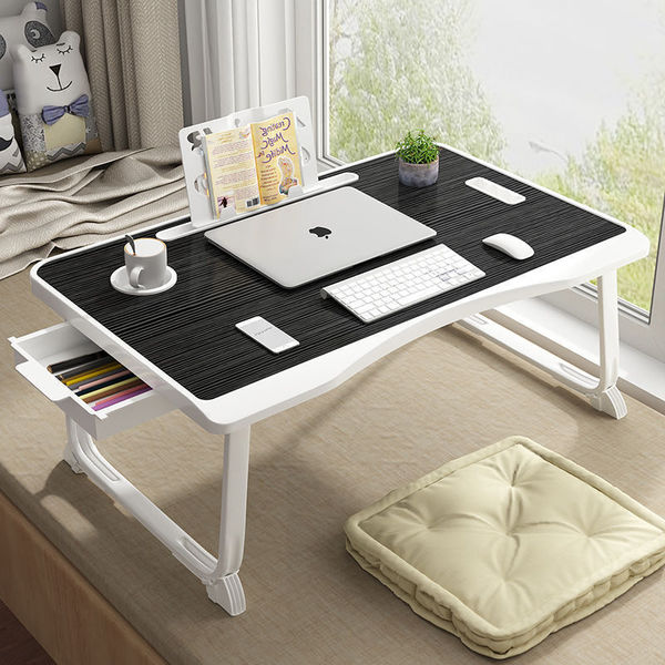 Folding the mobile lifting laptop computer table beside bed