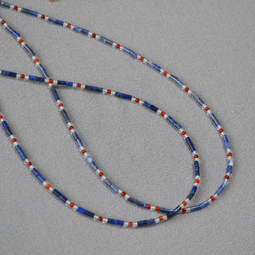 A handmade beaded necklace with new Chinese style, featuring a mix of vintage, literary, blue lapis lazuli, red agate, and genuine stones, with dot separators.