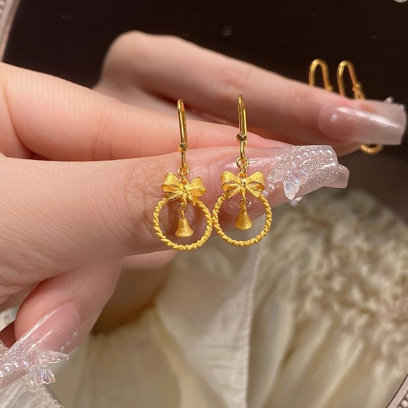 Princesa en fuga arco de oro campana pendientes ganchos de orejas dulces de alta calidad elegante temperamento orejas al por mayor