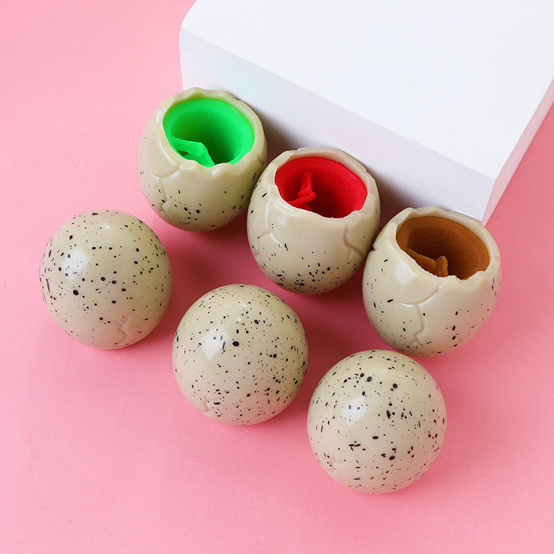 Red famosa novedad huevo de dinosaurio extruido juguete taza de dinosaurio para niños pellizco pellizco de escape bola de escape pegamento suave huevo