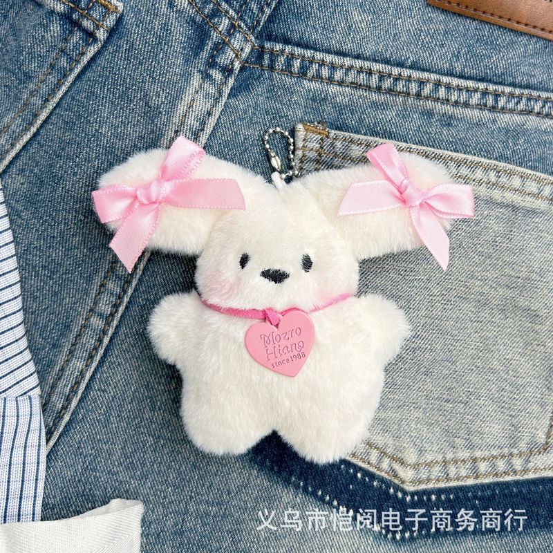 爆発的なリュックサックの蝶結びの飛行犬のメガネの子犬のぬいぐるみのペンダントの少女の心の漫画の大きい耳の犬は屋台を並べて卸売りします。|undefined