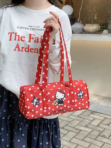 Retro polka dot cylindrical handbag, featuring fun cartoon appliqués, perfect for everyday use and creating a casual, stylish look