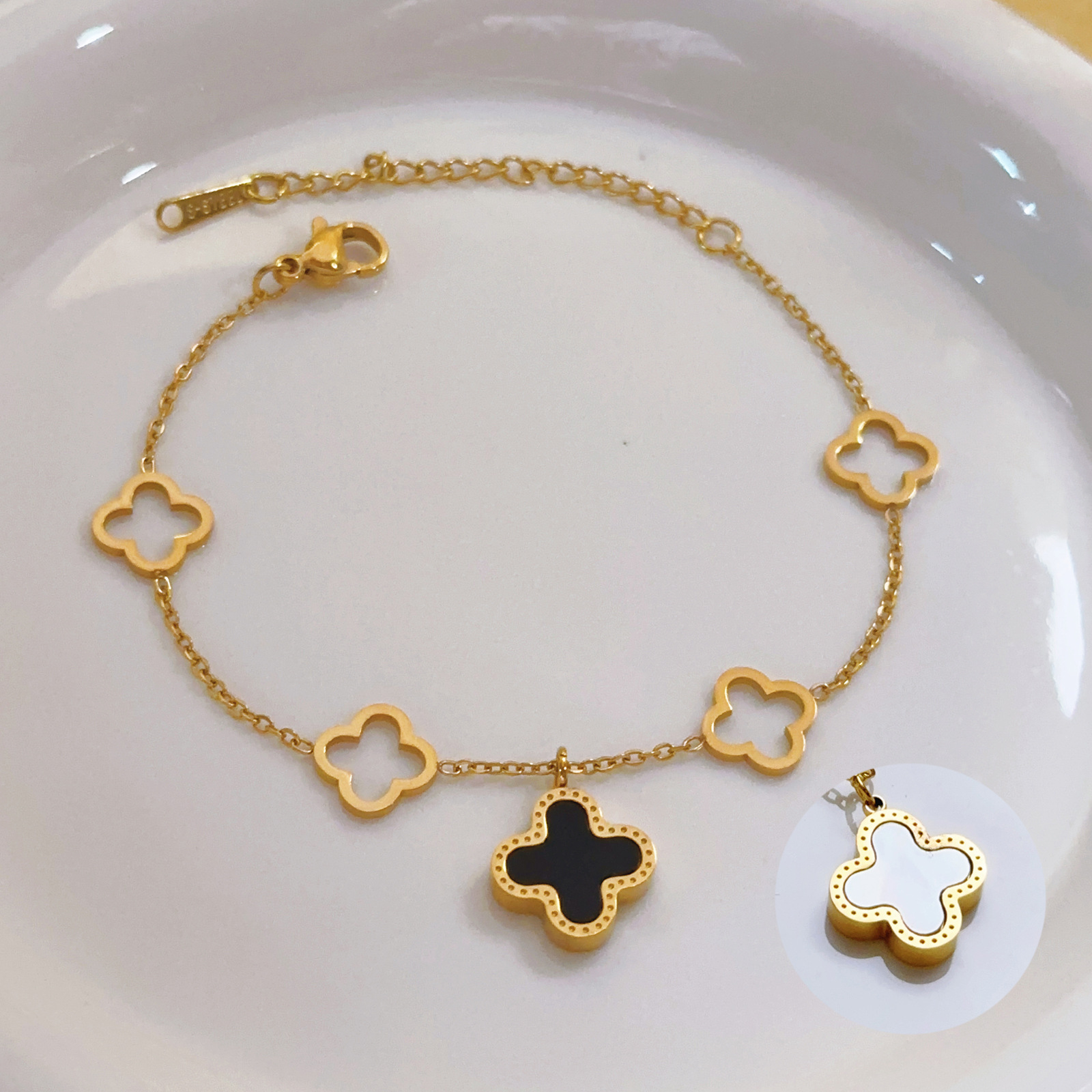 Cuatro hojas de hierba no se desvanecen pulsera de alta versión lujosa ligera en blanco y negro de doble cara oro lujosa joyería lujosa transfronteriza alta sensación conjunto