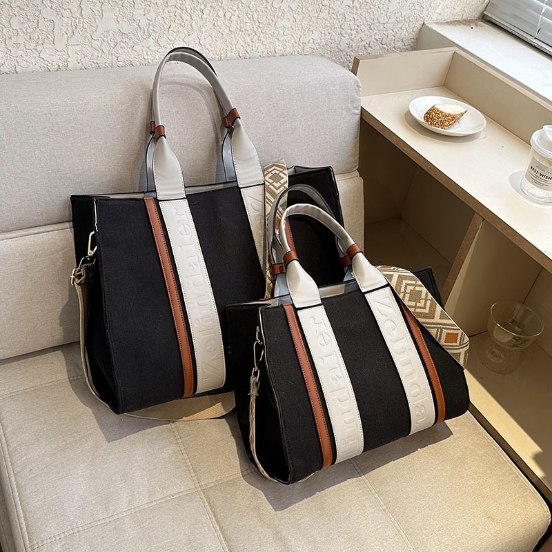 Bolso tote de lona de nuevo estilo con bloques de color, de gran capacidad para mujer, bolso cruzado de moda transfronteriza con sensación de alta gama para el trabajo y el transporte diario.