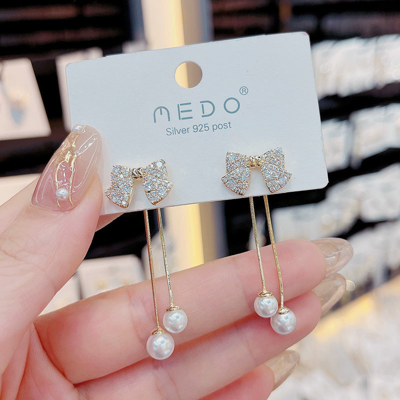 Elegant fashionable earrings with zircon with bow pearl with tassels