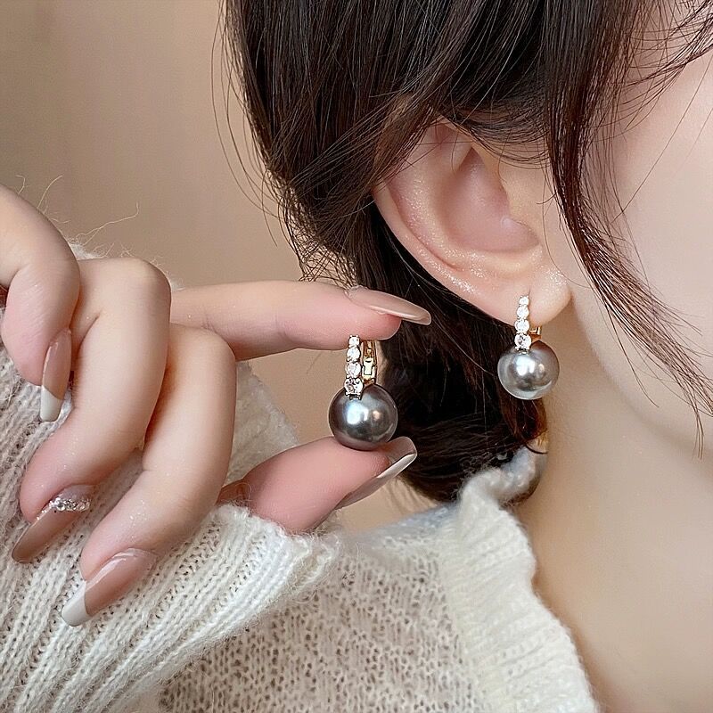 Small design fashionable elegant earrings from pearl with zircon