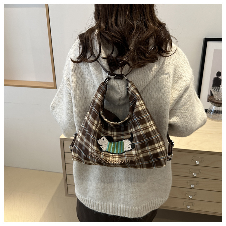 A new 2024 trendy and stylish backpack for women, featuring a cartoon checkered single-shoulder crossbody bag and a tote bag undefined