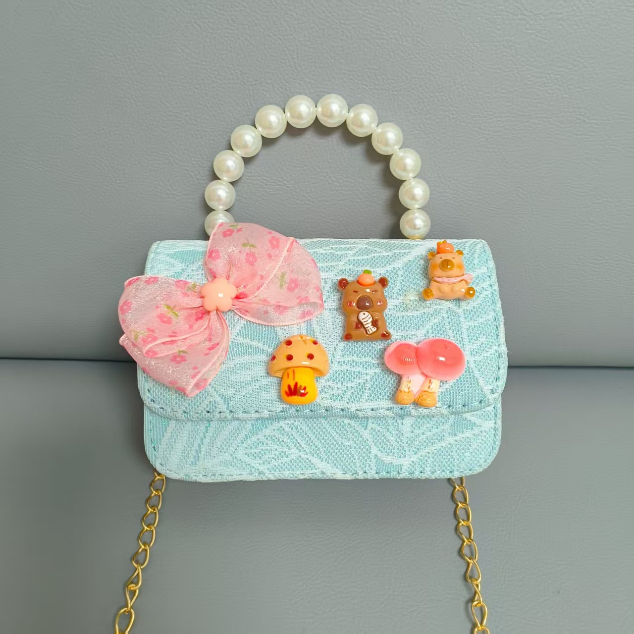 Bolsos para niños nuevos bolsos de perlas de arco para niñas bolsos de cinturón de estilo de fragancia bolsos de cadena bolsos de cambio bolsos