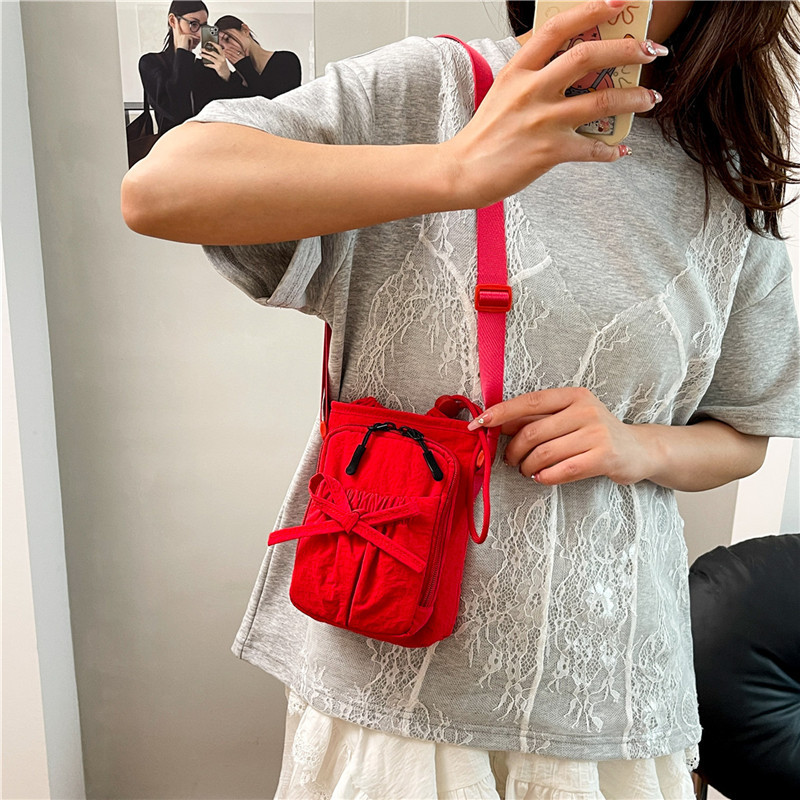Bolso de teléfono móvil de moda coreana 2025 verano nuevo bolso femenino lindo lazo bolso de hombro bolso de mensajero de lona casual