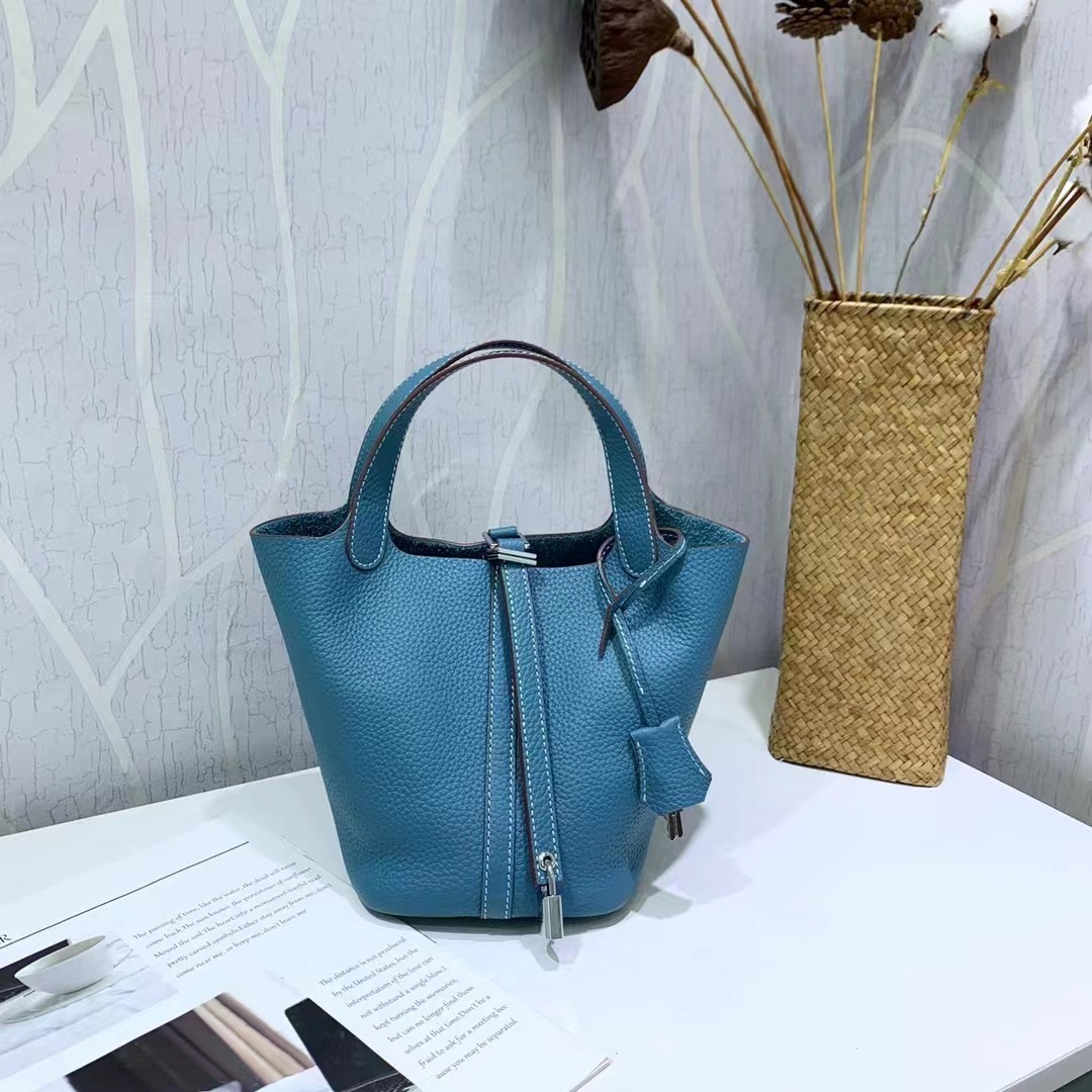 El nuevo bolso de cesta de verduras de marea de cuero togo de piel de vaca de capa superior 2025, bolso de cubo con cerradura de mano, bolso de cuero para mujer