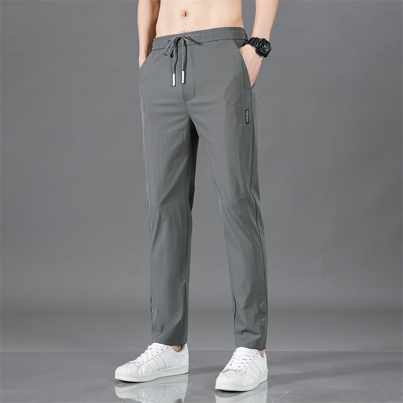Pantalones largos delgados de verano para hombres tendencia universal de hielo rápido secado deportivo relajado grande pantalones casuales al por mayor