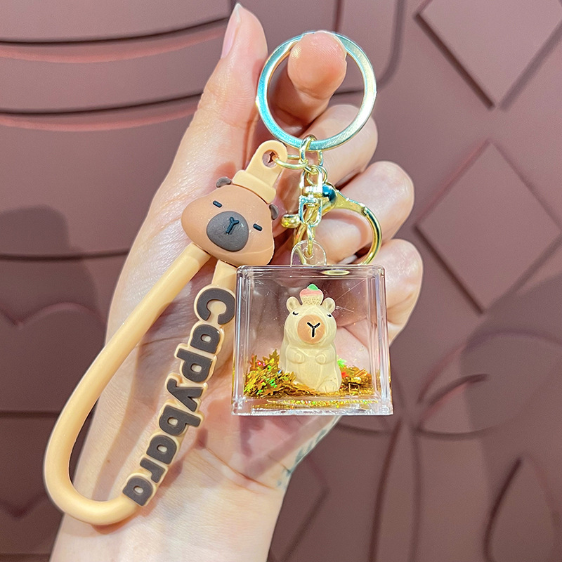 Cariño interesante en el aceite muñeca Kapibara llavero lindos colgantes delfines bolsa de automóvil garra máquina pequeños regalos al por mayor