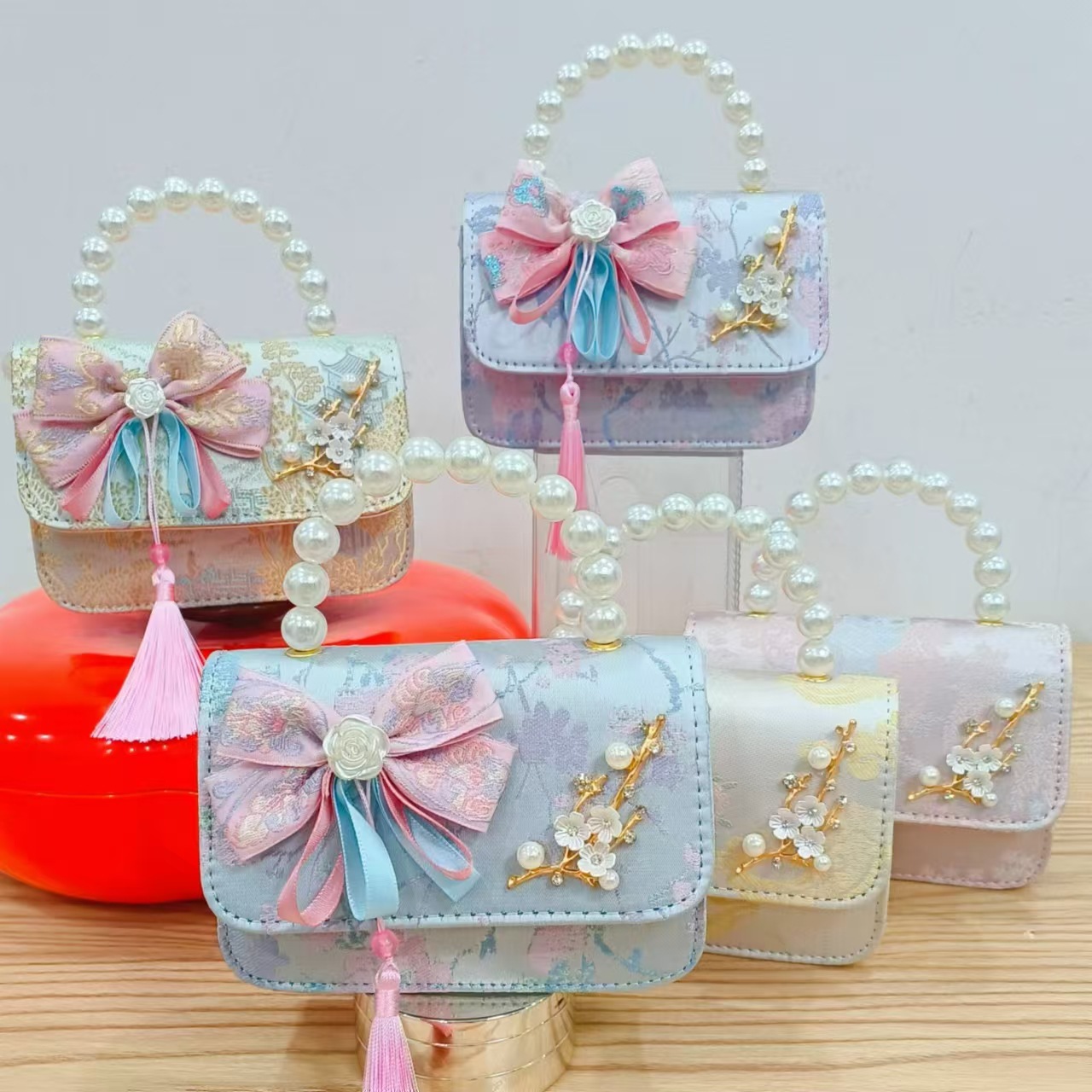 Bolsas de niños arco de estilo chino borda de niña pequeña princesa perla bolsa de cambio de mano al por mayor