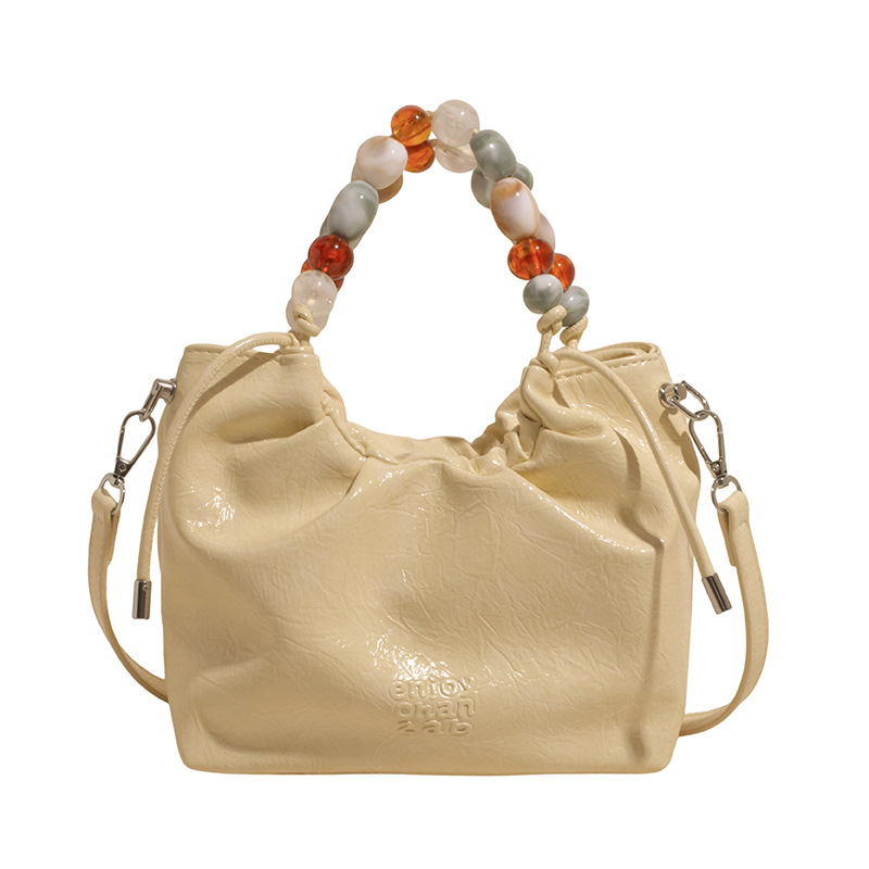 Versión coreana del bolso de nicho 2025 verano nuevo bolso femenino patrón de agarre de mano de alta gama bolso bandolera con cuentas y diamantes