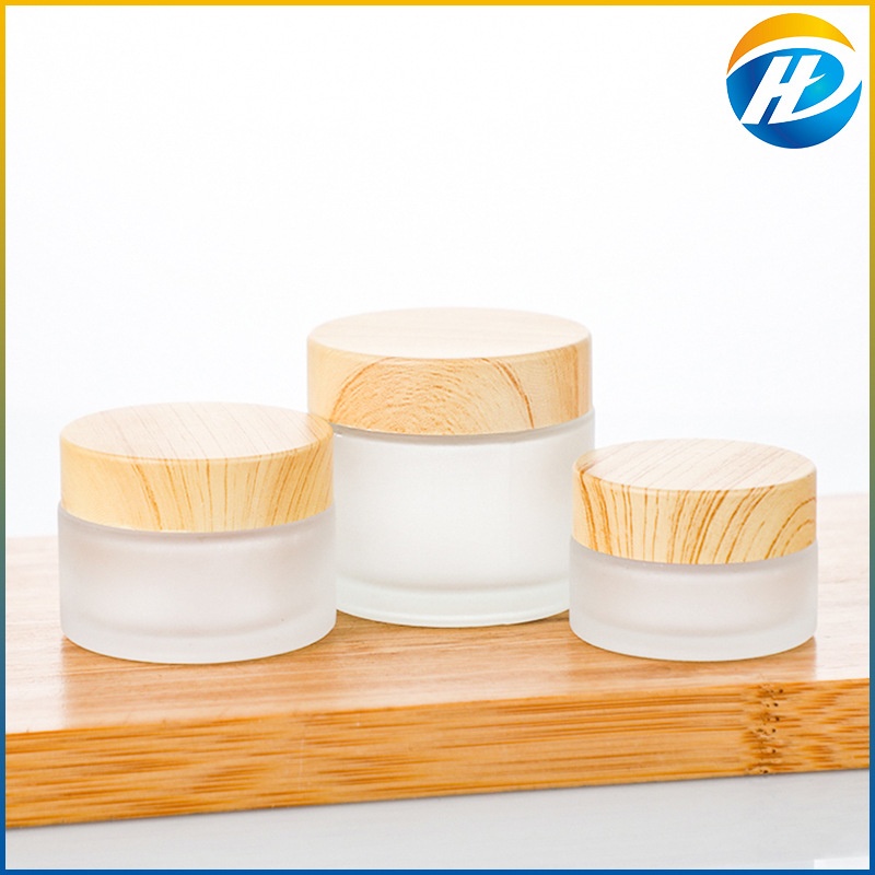 Venta al por mayor de madera grano cubierta botella de crema facial botella de crema botella cosmética de vidrio esmerilado 30g 50g crema sub-botella