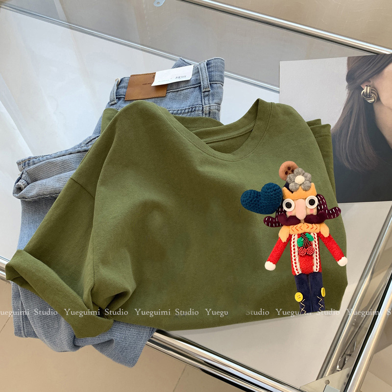 Green three dimensional cotton doll