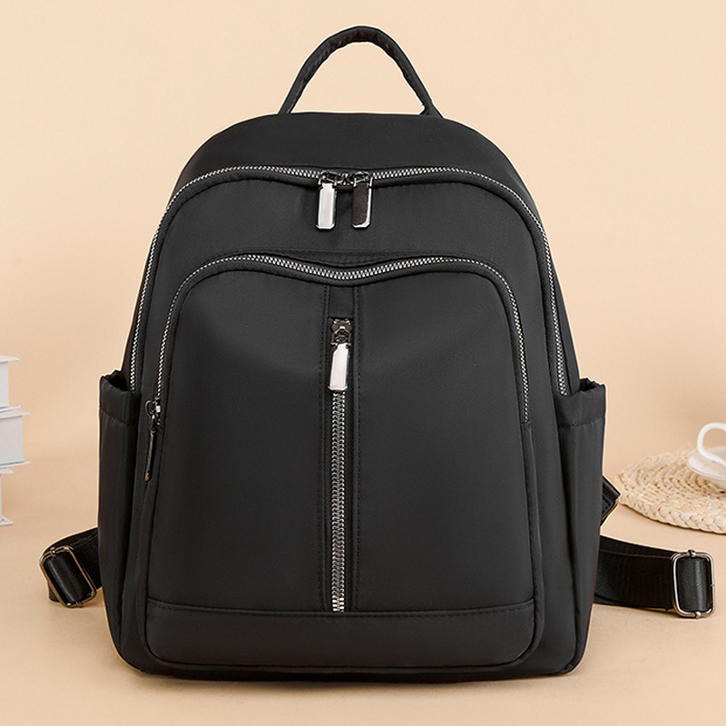 2023 nueva mochila de nailon casual para mujer, simple y versátil, gran capacidad, color sólido, mochila de mamá de viaje al por mayor