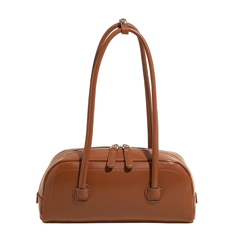 High-end nicho de moda bolso de hombro de mano para mujeres 2025 verano nuevo estilo simple bolso de viaje de palo bolso debajo de la axila