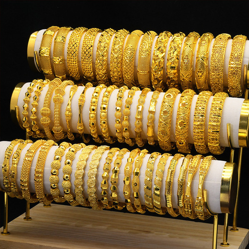 Cross-border best-selling ladies' gold-plated bangles with hollow carved totem design, bride's bracelets wholesale