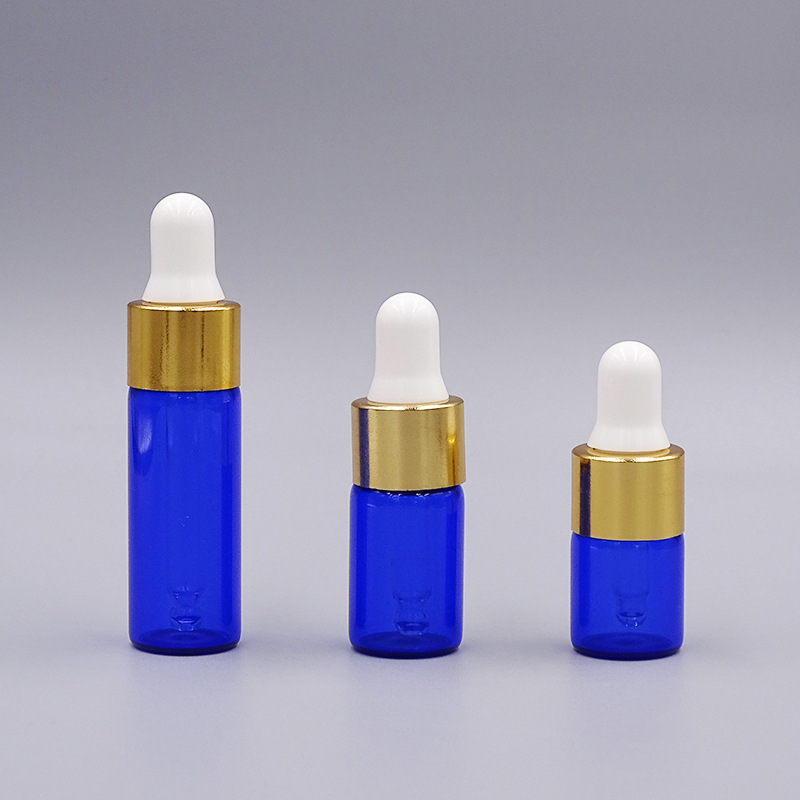 2ml una pieza 3528; botella azul con anillo de oro; vidrio