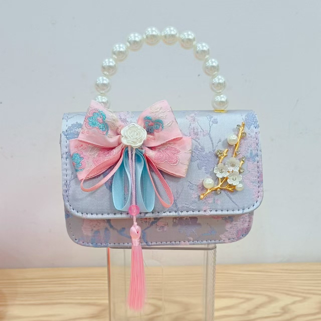 Bolsas de niños arco de estilo chino borda de niña pequeña princesa perla bolsa de cambio de mano al por mayor