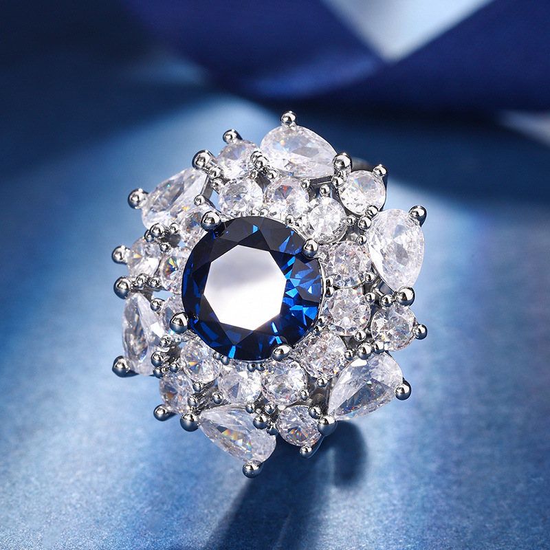 Otoño e Invierno nuevo estilo Zhuang Sheng joyería cobre fondo chapado en oro simulación azul punta cristal redondo temperamento luz lujo traje femenino 10mm7m