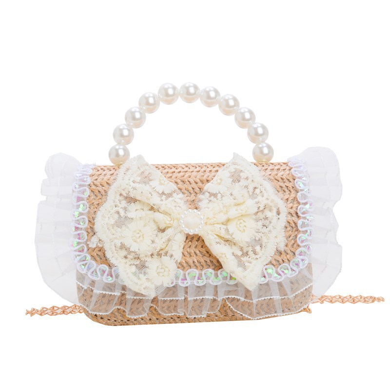 2025 verano nuevo arco de paja bolsa de perla portátil inclinada pequeña fragancia bolsa de moda para niños mochila para niñas