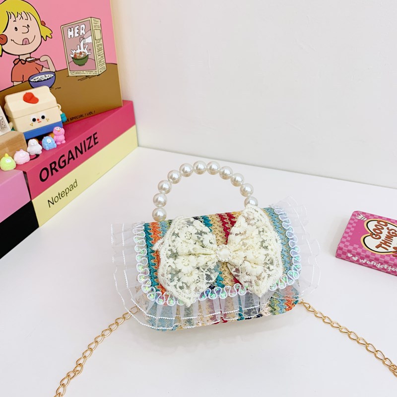 2025 verano nuevo arco de paja bolsa de perla portátil inclinada pequeña fragancia bolsa de moda para niños mochila para niñas