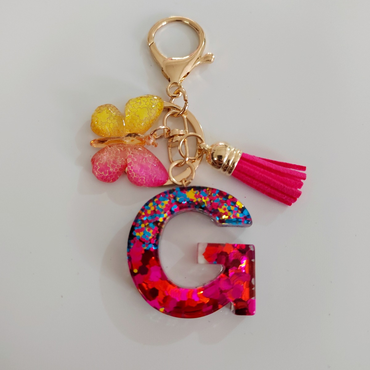 Ventas transfronterizas calientes de letras inglesas de color mixto colgante de llavero colgante de mariposa fringe de resina de llavero colgante de joyería