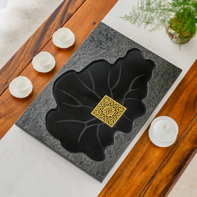 Replace the central panel of the Wuheshi tea tray integrated tea table with an embedded fire-burned stone water-leaking stone slab.