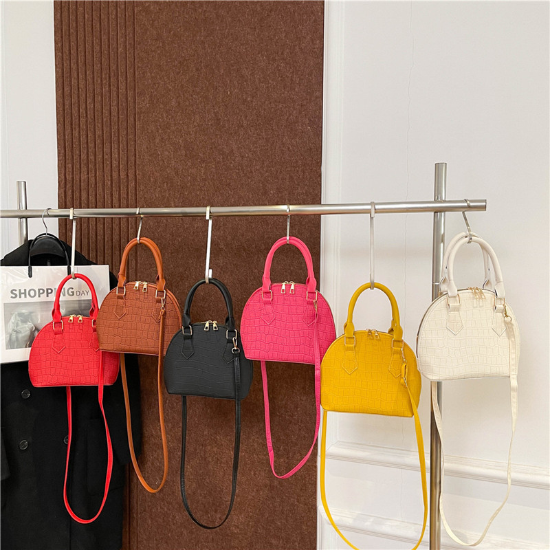 Bolso de mano de piedra para mujeres 2024 nuevo bolso de concha de textura bolso de hombro de moda minimalista estilo elegante mochila