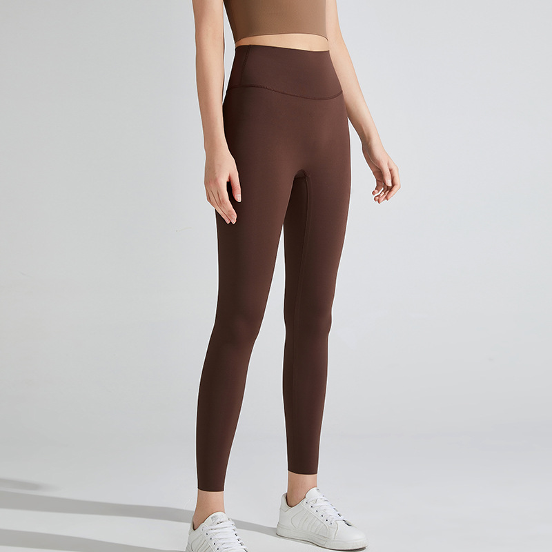 Nuevos pantalones de yoga desnudos transfronterizos Lycra de cintura alta de mujer pantalones de fitness de levantamiento de cadera deportes al aire libre ropa de yoga ajustada de secado rápido