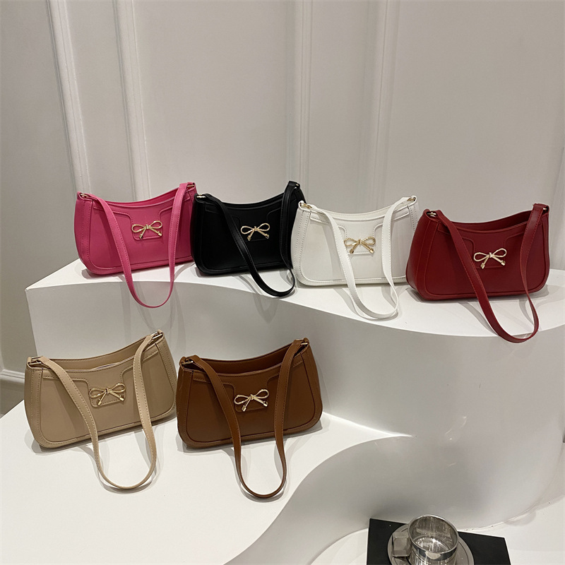 Bolso de hombro popular de este año con lazo para damas de gran capacidad 2025 color sólido nuevo bolso de axila simple de textura de moda