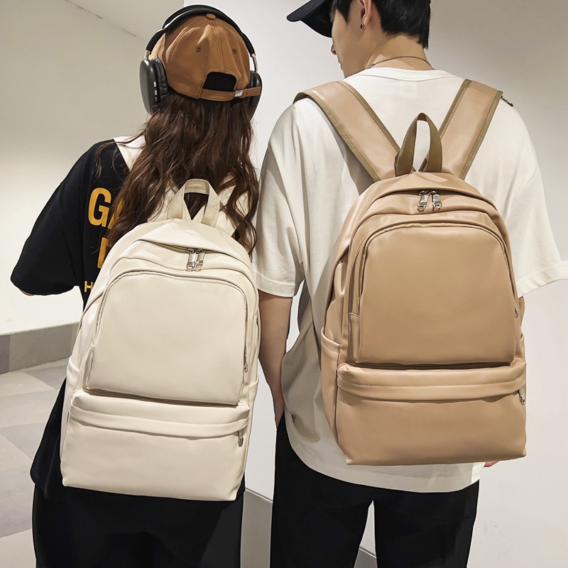 2023 invierno nueva mochila de pareja de gran capacidad simple y versátil mochila de computadora de viaje de cuero suave mochila escolar al por mayor