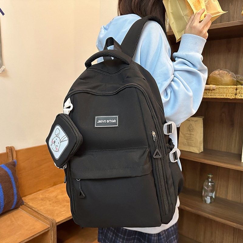 Mochila de estudiantes de moda simple 2025 nueva mochila casual de color sólido mochila de viaje de gran capacidad soporte personalizado