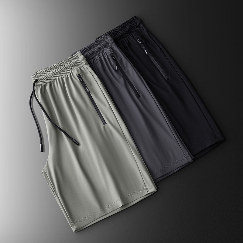 2025 nuevo verano más el tamaño de los pantalones deportivos de nailon pantalones de cinco puntos para hombres pantalones cortos de seda de hielo de color sólido de secado rápido fábrica al por mayor