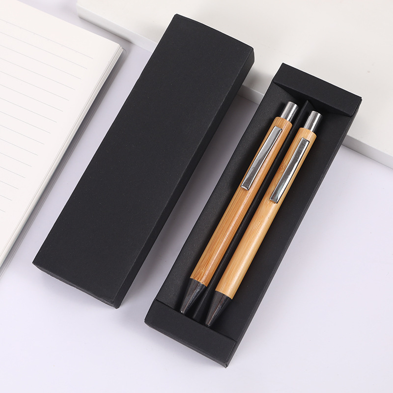 A set of two black pen cases, perfect as a gift, can be customized with a logo. These smooth-writing ballpoint pens feature a push-button mechanism and are made of bamboo and wood