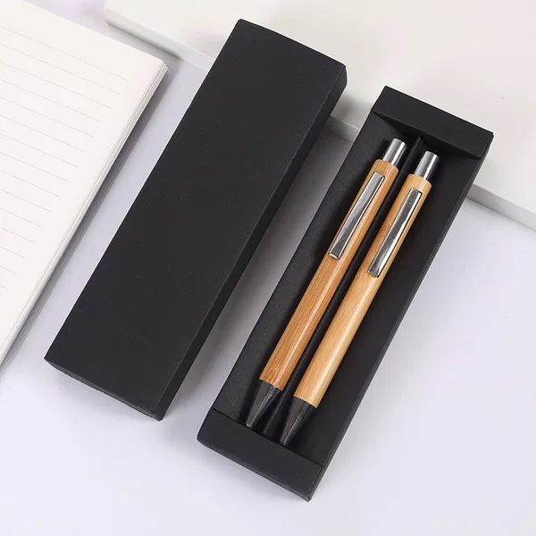A set of two black pen cases, perfect as a gift, can be customized with a logo. These smooth-writing ballpoint pens feature a push-button mechanism and are made of bamboo and wood