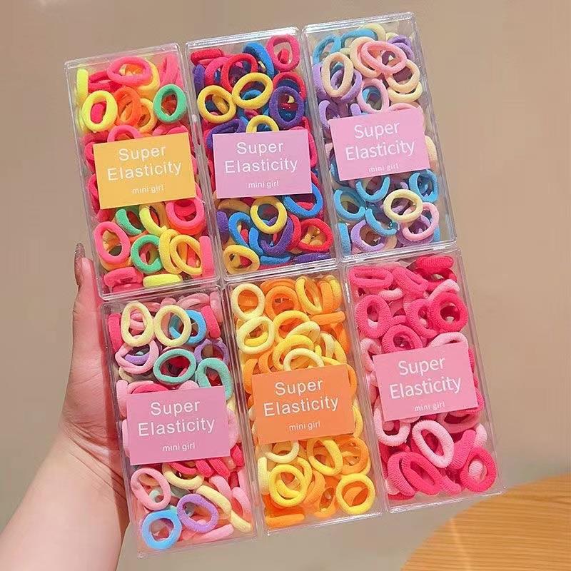 Asequible caja de almacenamiento de Corea del Sur de los niños pequeño tamaño cabeza cuerda bebé toalla anillo no duele pelo cabeza cuerda macaron pelo anillo