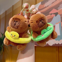 新商品の浮き輪のカピバラのぬいぐるみのカピバラのぬいぐるみのぬいぐるみのぬいぐるみが枕を抱いています。