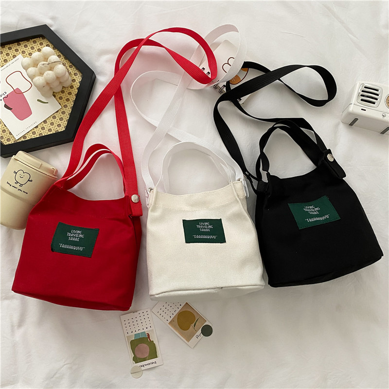 Bolso de mujer nuevo estilo coreano simple bolso de lienzo de chicas fresco de color sólido bolso de cubo de moda moda bolsa de mochila casual